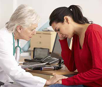 Doctor with depressed woman patient
