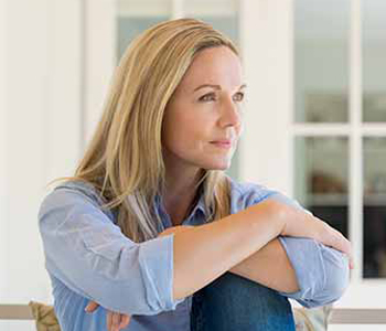 Woman sitting outside the house and thinking about her new idea